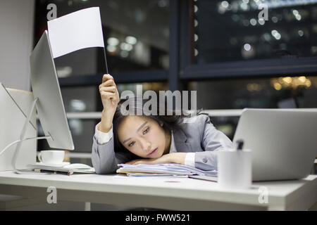 Businesswoman working late in office Stock Photo