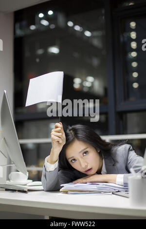 Businesswoman working late in office Stock Photo