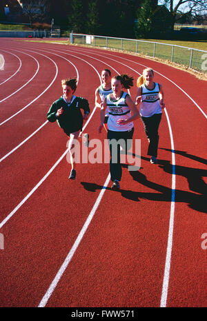 High school girls track team running on synthetic surface outdoor track Stock Photo