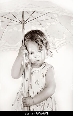 little sad girl with umbrella Stock Photo