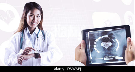 Composite image of asian doctor using her smart watch Stock Photo