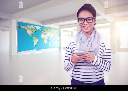 Composite image of smiling asian woman using smartphone Stock Photo