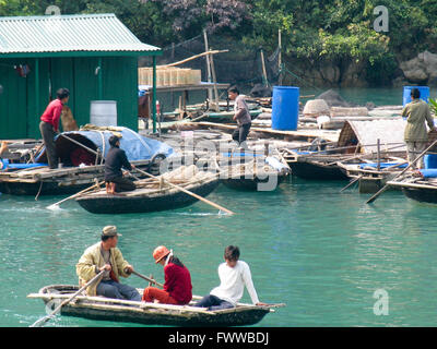 Traditional Vietnamese fishers on boats and floating village, Stock Photo