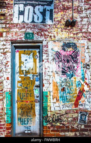Grunge door in New York City on building exterior covered in graffiti