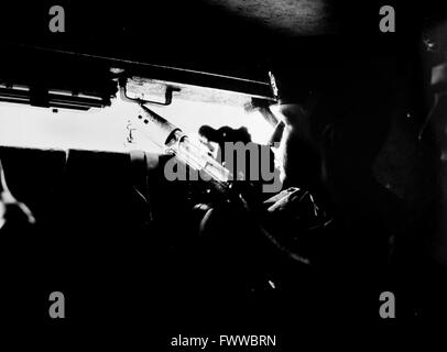 Northern Ireland 1984 - A soldier from the Queen's Regiment on patrol inside an armoured vehicle known as a 'pig' around the streets of West Belfast Stock Photo