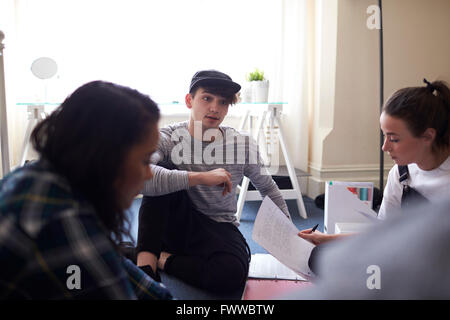 Group Of Students Collaborating On Project Together Stock Photo