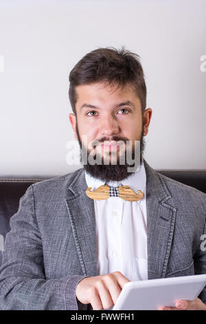 Bearded man in a suit wearing a bow tie Stock Photo