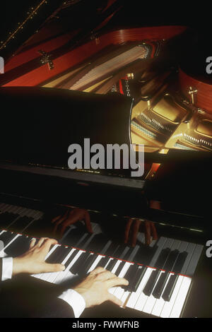 Close-up of a Man's Hands playing a Grand Piano Stock Photo
