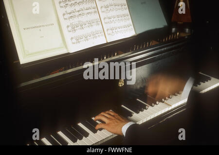 Close-up of a Man's Hands playing a Grand Piano Stock Photo