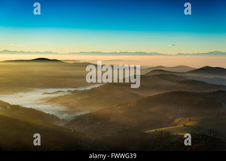 View from the Belchen south on the Wiesental valley and the Swiss Alps, morning atmosphere with fog, Black Forest Stock Photo