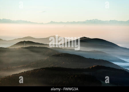 View from the Belchen south on the Wiesental valley and the Swiss Alps, morning atmosphere with fog, Black Forest Stock Photo