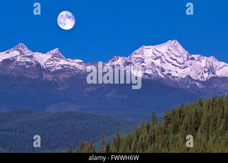 moon over mcdonald peak in the mission mountains above the swan valley near condon, montana Stock Photo