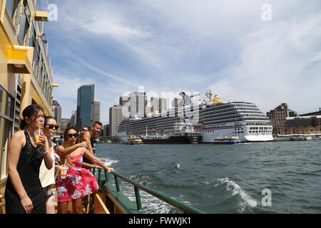 Sydney, Australia. 2 March 2016. Passengers on the Manly ferry in Sydney Harbour pass by the docked Carnival Spirit. Stock Photo