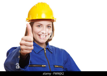 Happy female worker in overall holding thumbs up Stock Photo