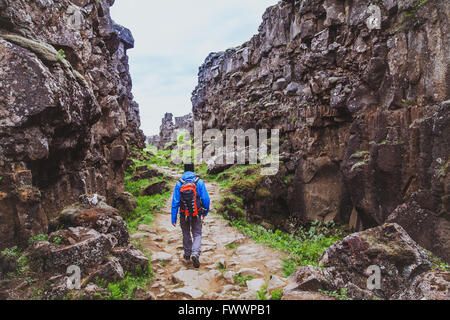 hiking in rocky canyon, backpacker walking in the nature, Iceland Stock Photo