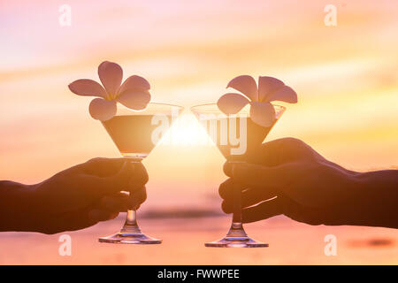 tropical cocktails on the beach, couple of hands with glasses Stock Photo