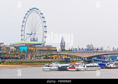 LONDON, ENGLAND - APRIL 29, 2011: London Eye and Big Ben near Waterloo Bridge in London, UK. London Eye is Ferris wheel on South Bank of Thames River. Waterloo bridge is a foot traffic and road bridge Stock Photo