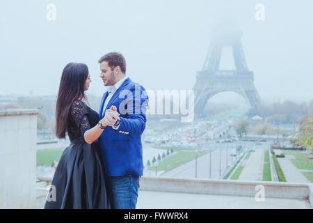 romantic moment near Eiffel tower, portrait of couple in love Stock Photo