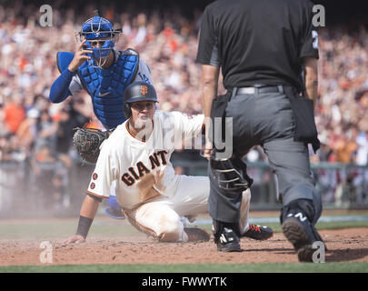 San Francisco, CA, USA. 7th Apr, 2016. San Francisco Giants Joe Panik and Los Angeles Dodgers catcher Austin Barnes look at the umpire as he scores in the sixth inning during the home opener at AT&T Park on Thursday April 7, 2016 in San Francisco, Calif. Credit:  Paul Kitagaki Jr/Sacramento Bee/ZUMA Wire/Alamy Live News Stock Photo