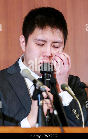 Japanese badminton player Kenichi Tago cries during a news conference on April 8, 2016, Tokyo, Japan. An NTT East badminton team representative, Masayuki Okumoto, said that Keinichi Tago had lost approximately 10 million yen through gambling and had visited an illegal casino 60 times. He also said that world number 2, Kento Momota had lost 500,000 yen. Gambling is illegal in Japan and can carry a prison sentence and both the badminton stars admitted visiting a yakuza operated casino. Momota and Tago were expected to represent Japan in the Rio Olympic Games with Momota a medal favorite. The two Stock Photo