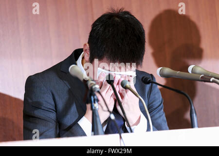 Japanese badminton player Kenichi Tago cries during a news conference on April 8, 2016, Tokyo, Japan. An NTT East badminton team representative, Masayuki Okumoto, said that Keinichi Tago had lost approximately 10 million yen through gambling and had visited an illegal casino 60 times. He also said that world number 2, Kento Momota had lost 500,000 yen. Gambling is illegal in Japan and can carry a prison sentence and both the badminton stars admitted visiting a yakuza operated casino. Momota and Tago were expected to represent Japan in the Rio Olympic Games with Momota a medal favorite. The two Stock Photo