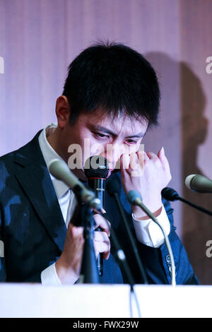 Japanese badminton player Kenichi Tago cries during a news conference on April 8, 2016, Tokyo, Japan. An NTT East badminton team representative, Masayuki Okumoto, said that Keinichi Tago had lost approximately 10 million yen through gambling and had visited an illegal casino 60 times. He also said that world number 2, Kento Momota had lost 500,000 yen. Gambling is illegal in Japan and can carry a prison sentence and both the badminton stars admitted visiting a yakuza operated casino. Momota and Tago were expected to represent Japan in the Rio Olympic Games with Momota a medal favorite. The two Stock Photo