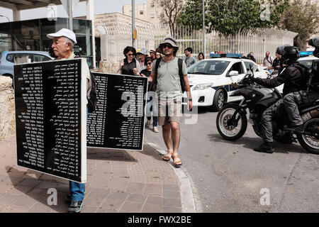 Jerusalem, Israel. 8th April, 2016. Jews and Arabs march together in a procession carrying plaques bearing the names of the victims of the Deir Yassin Massacre, under tight police protection, to the few remaining structures of the 1948 Arab village invaded and destroyed. Commemoration organized by Zochrot (Remembering), seeking to raise public awareness of the Palestinian Nakba (Catastrophe). Credit:  Nir Alon/Alamy Live News Stock Photo