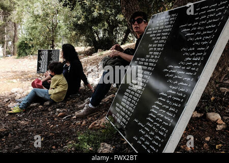 Jerusalem, Israel. 8th April, 2016. Jews and Arabs march together in a procession carrying plaques bearing the names of the victims of the Deir Yassin Massacre, under tight police protection, to the few remaining structures of the 1948 Arab village invaded and destroyed. Commemoration organized by Zochrot (Remembering), seeking to raise public awareness of the Palestinian Nakba (Catastrophe). Credit:  Nir Alon/Alamy Live News Stock Photo