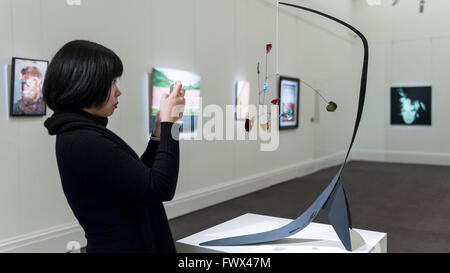 London, UK.  8 April 2016.  A Sotheby's staff member views Alexander Calder's 'Untitled', 1942, est. $3-4million at Sotheby's auction preview, at their New Bond Street gallery, of works to be in the upcoming New York Impressionist, modern and contemporary art sale Credit:  Stephen Chung / Alamy Live News Stock Photo