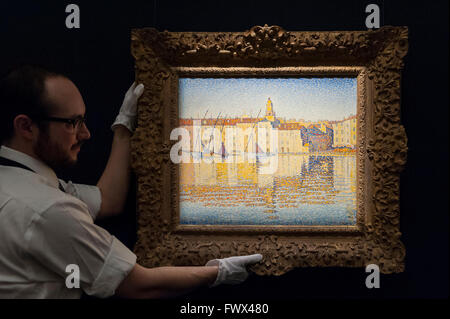 London, UK.  8 April 2016.  A Sotheby's technician shows Paul Signac's 'Maisons Du Port, Saint Tropez', 1892, est. $8-12million.  Sotheby's auction preview, at their New Bond Street gallery, of works to be in the upcoming New York Impressionist, modern and contemporary art sale. Credit:  Stephen Chung / Alamy Live News Stock Photo