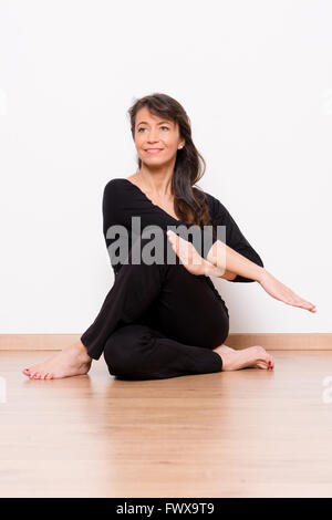 Middle aged woman doing sports in front of white background Stock Photo