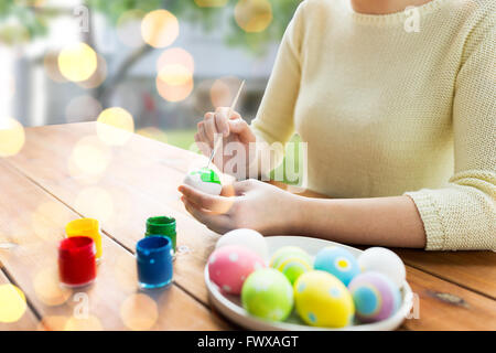 close up of woman hands coloring easter eggs Stock Photo