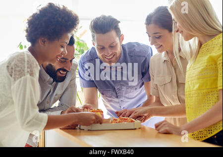 happy business team eating pizza in office Stock Photo