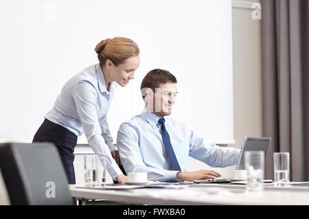 businessman and secretary with laptop in office Stock Photo