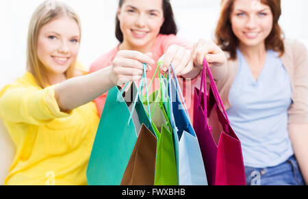 close up of happy teenage girls with shopping bags Stock Photo