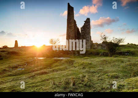 Sunset over the ruins of old tine mine engine houses on Bodmin Moor in Cornwall Stock Photo