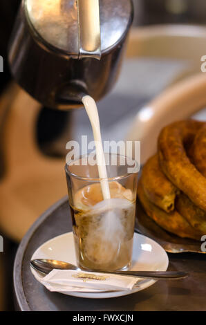 That glorious moment when the hot milk hits your first coffee of the day. Stock Photo