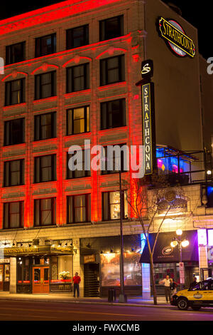 Taxicab waiting for customer outside Strathcona hotel and pub  at night-Victoria, British Columbia, Canada. Stock Photo