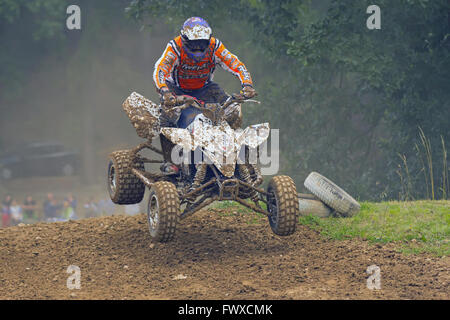 Racer is jumping in the quad motorbike race Stock Photo