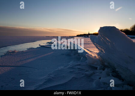 The sun sets behind an ice ridge on Lake Ontario in Kingston, Ont., on March 3, 2016. Stock Photo