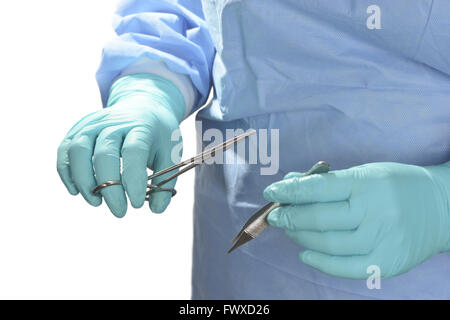 Surgeon uses forceps and hemostats in operating room. Stock Photo