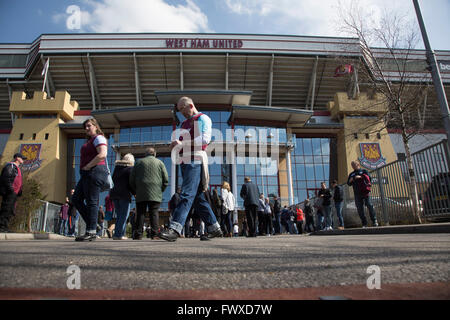 Fans arriving outside the Betway Stand at the Boleyn Ground before West Ham United hosted Crystal Palace in a Barclays Premier League match. The Boleyn Ground at Upton Park was the club's home ground from 1904 until the end of the 2015-16 season when they moved into the Olympic Stadium, built for the 2012 London games, at nearby Stratford. The match ended in a 2-2 draw, watched by a near-capacity crowd of 34,857. Stock Photo