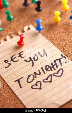 Message or reminder board with "see you tonight" note Stock Photo