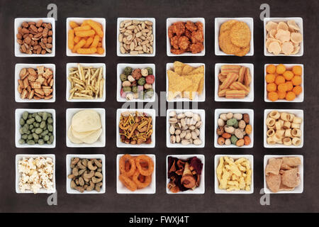 Large savory snack food selection in square porcelain bowls. Stock Photo