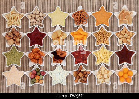 Large crisp and dip snack food selection in porcelain star dishes over bamboo  background. Stock Photo