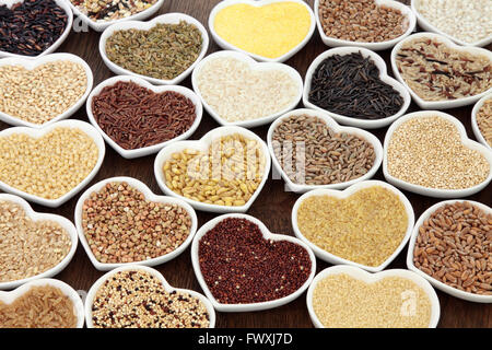 Large staple grain and cereal food selection in porcelain bowls over oak background. Stock Photo