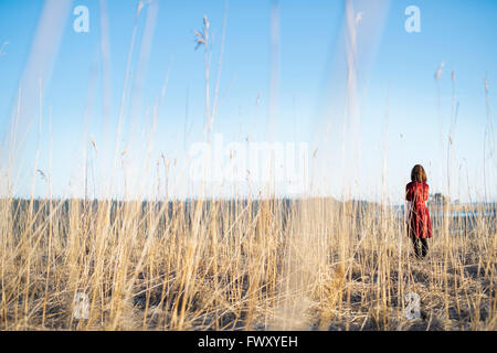 Finland, Varsinais-Suomi, Young woman standing in field