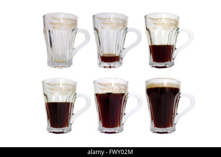 Glass coffee cups with different amounts of black coffee in them photographed against a white background. Stock Photo