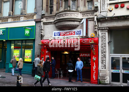 People chatting and smoking outside entrance to The Borough Arms pub at 8 St Mary Street, Cardiff, South Glamorgan, Wales, United Kingdom Stock Photo