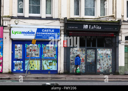Papered over shop fronts of small businesses that have shut down, Cardiff, South Glamorgan, Wales, United Kingdom Stock Photo